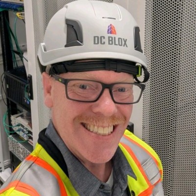 Tom Lasswell in a DC BLOX data center, hard hat and high-vis